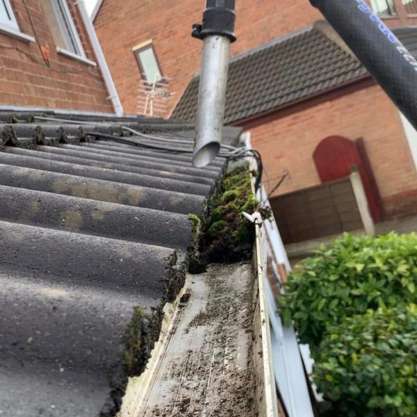 Professional Gutter Cleaning Wigan removing leaves and debris